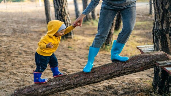 an infant walking a log ramp