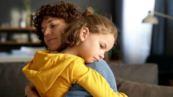 Young mom embracing and calming her child