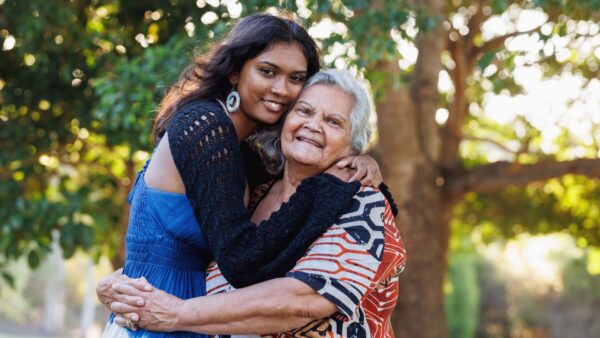 Aboriginal younger woman hugging Aboriginal female elder