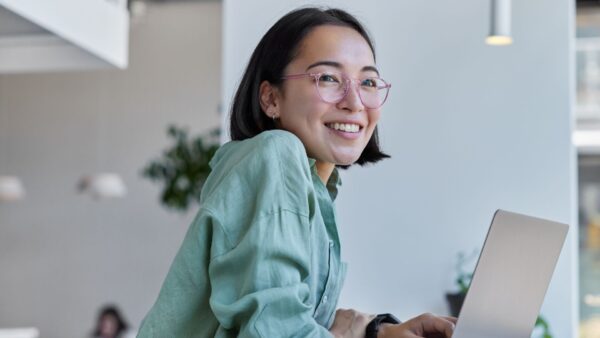 Asian woman smiling with her laptop