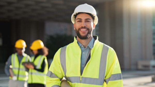 Happy man, architect and city for construction management or teamwork in leadership on site