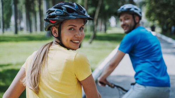 Joyful woman enjoying bicycle ride with her husband