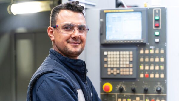 Professional lathe worker man working with milling machine in factory